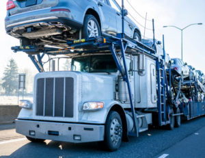 a car hauler fully loaded with passenger cars