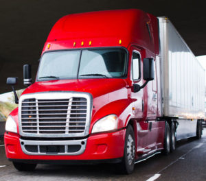 a new conventional cab truck with a shiny red cab