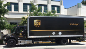 a UPS delivery truck parked next to a building