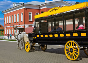 restored horse-drawn omnibus carrying tourists