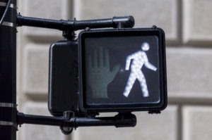 lit up walk signal at leading pedestrian interval crosswalk