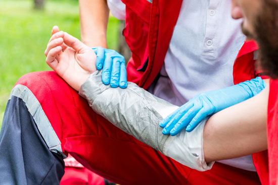 Los Angeles burn injury attorney can assist this victim whose burned arm is being bandaged by a paramedic