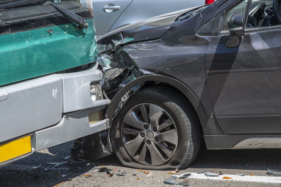 Los Angeles bus accident lawyer is ready to help occupants of this black car that crashed into a green city bus