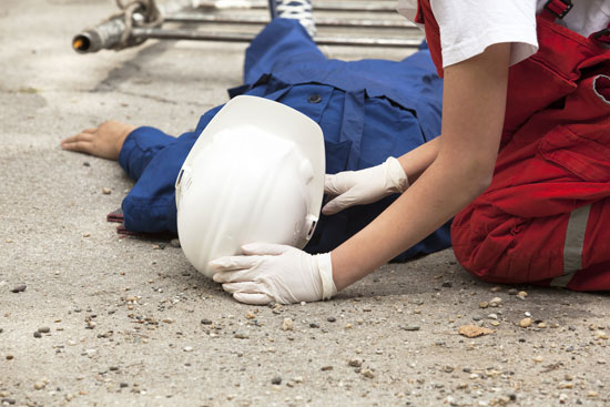 Los Angeles construction accident attorney can fight for this injured worker who is on the ground being assisted