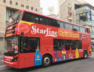 red Los Angeles double-decker bus carrying tourists on Hollywood Boulevard