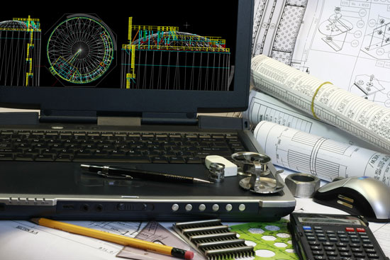 blueprints, computer, and calculator on the desk of a Los Angeles product liability attorney