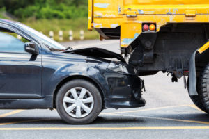 Los Angeles truck accident attorney is ready to help occupants of this black car that collided with a yellow dump truck