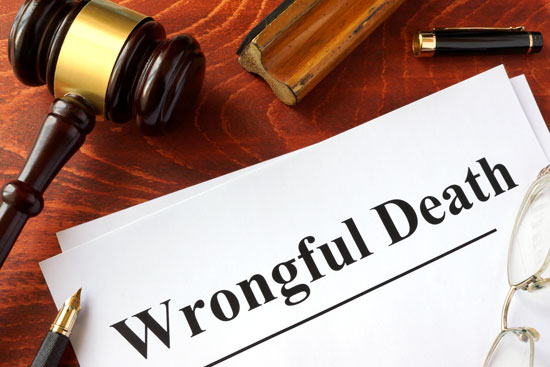 a gavel, pen, stamp, and a sign that says wrongful death on the desk of a Los Angeles wrongful death attorney