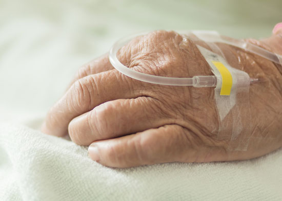 an intravenous line with antibiotics in the hand of a patient who needs a nursing home infections attorney