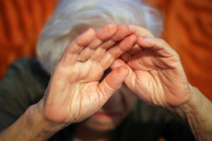 nursing home sexual abuse attorney can assist this elderly lady who raised her hands to her face in fear