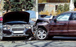 two crashed cars in the middle of a street after a side-impact crash