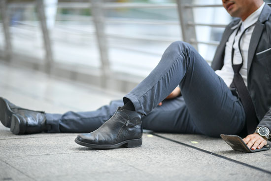young man sitting on the floor after a fall needs help of the best slip and fall attorney Los Angeles can offer