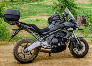 black sport touring motorcycle parked on a grassy area