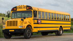 truck chassis type C school bus standing on the side of a road