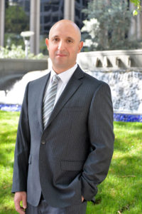 Dmitriy Cherepinskiy standing in front of an office building