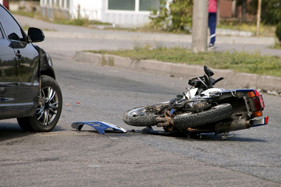 the rider of this bike that crashed into a black car needs the motorcycle accident lawyer Los Angeles riders trust